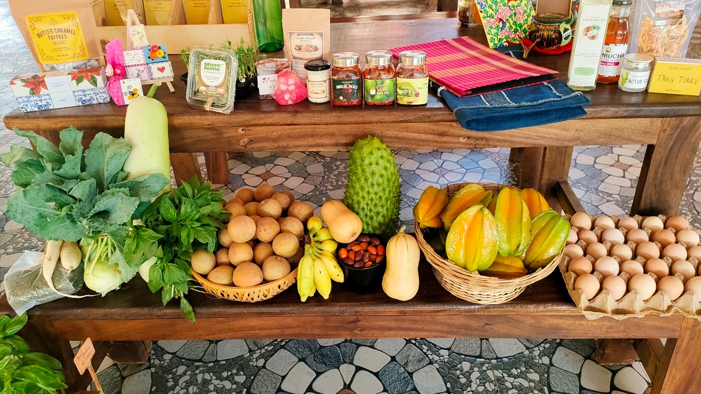 A market table at Homegrown & Homemade laden with vegetables, fruit, eggs, preserves, microgreens and handmade goods